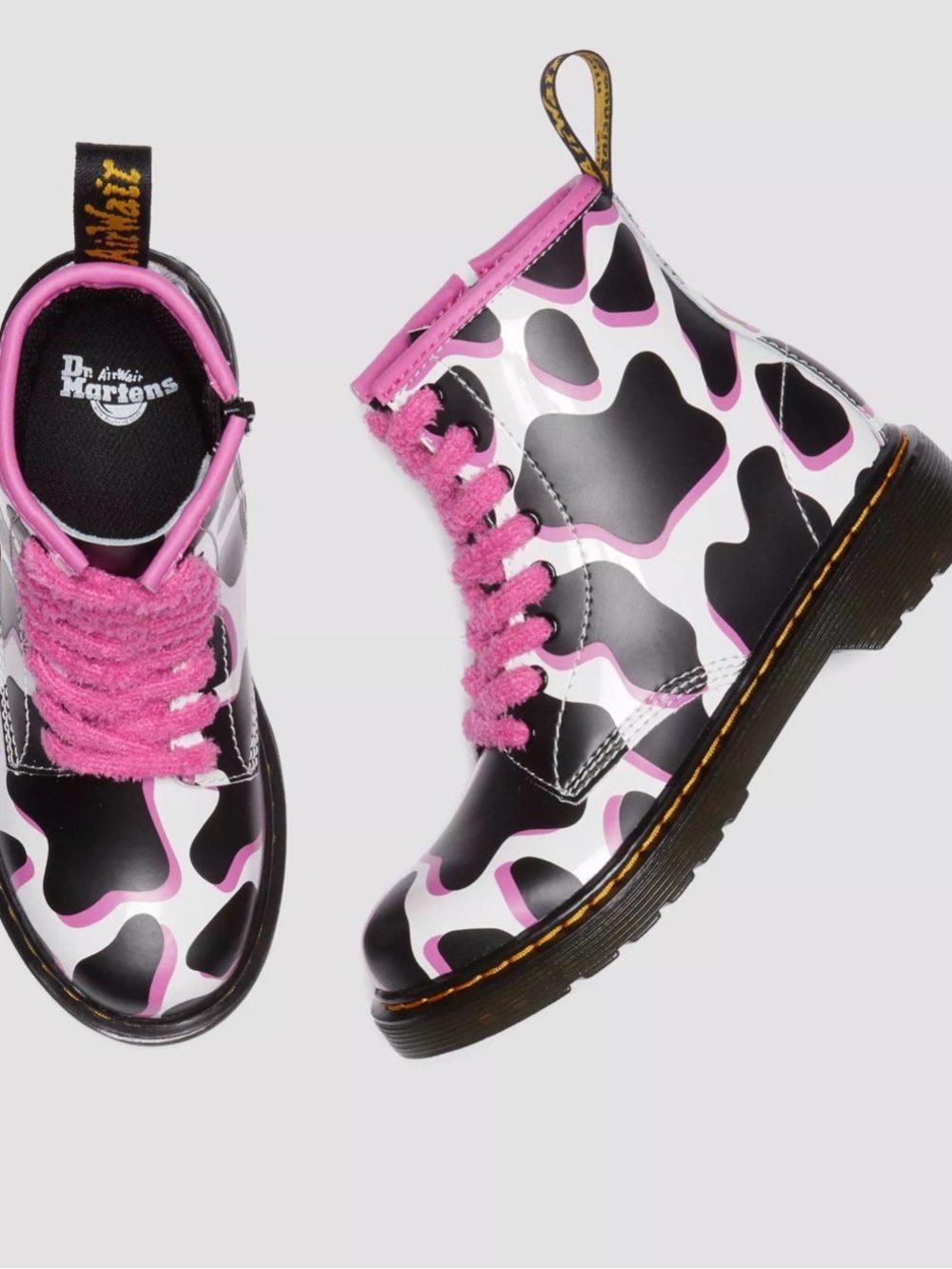 Dr. Martens Black & White Cow Print Boots with Pink Trim